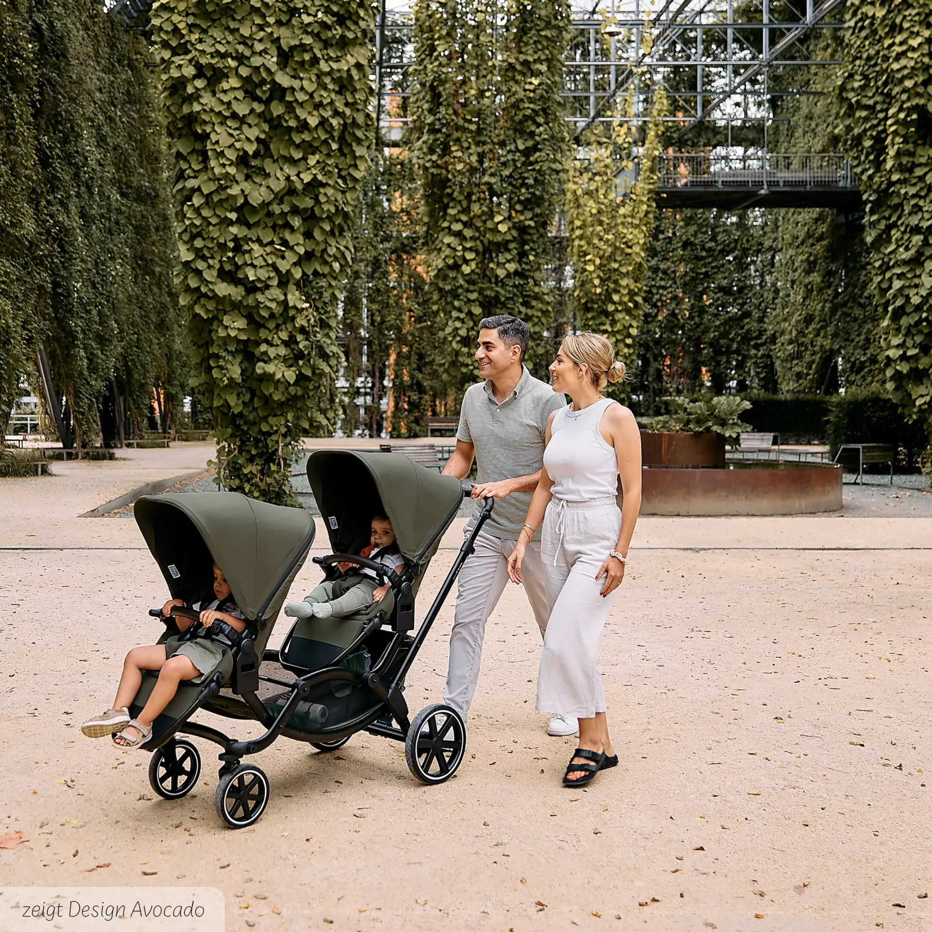familie geht mit geschwisterwagen spazieren